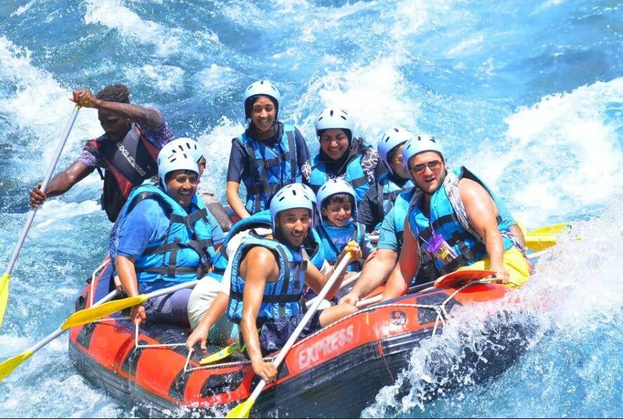 Rafting team high-fiving after a thrilling ride